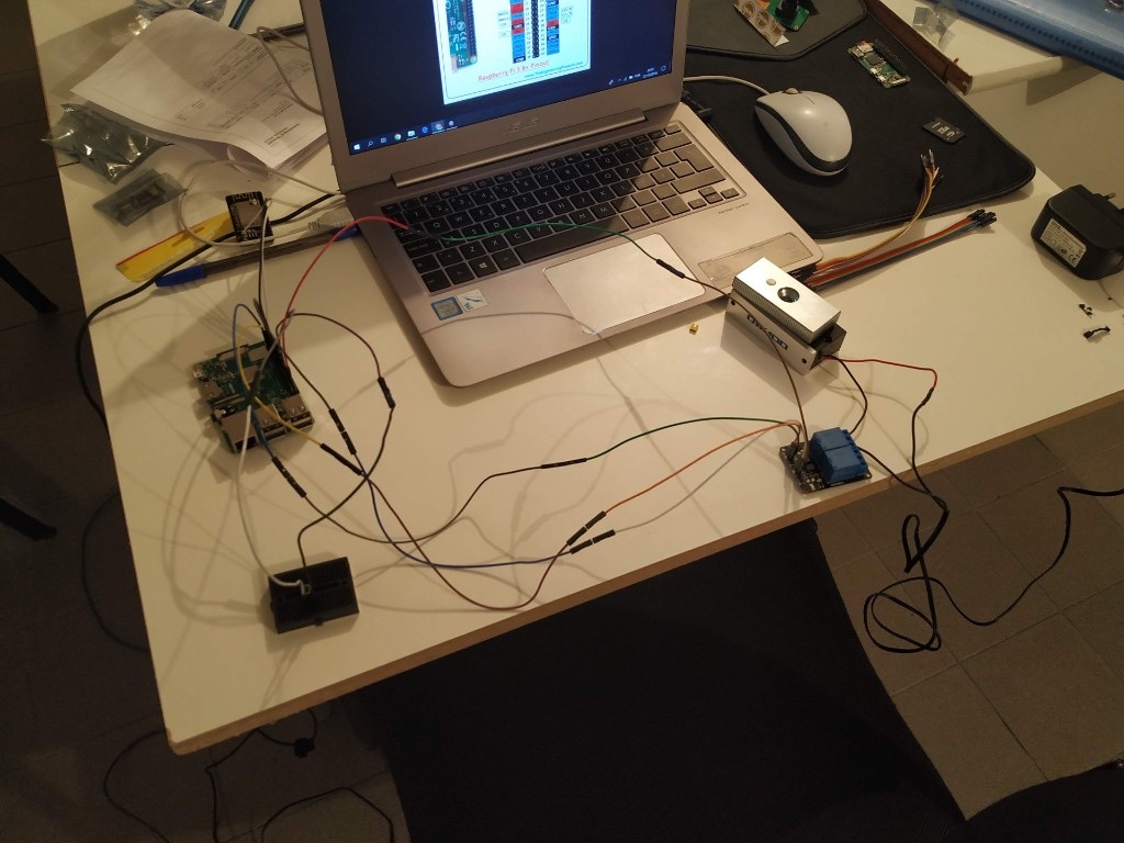 Laptop wired to a Raspberry Pi and a relay board on a workbench